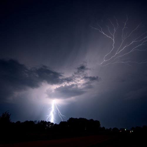 Lightning strikes the ground and spreads into the sky as a lightning crawler nears Jeanette, Arkansas, USA